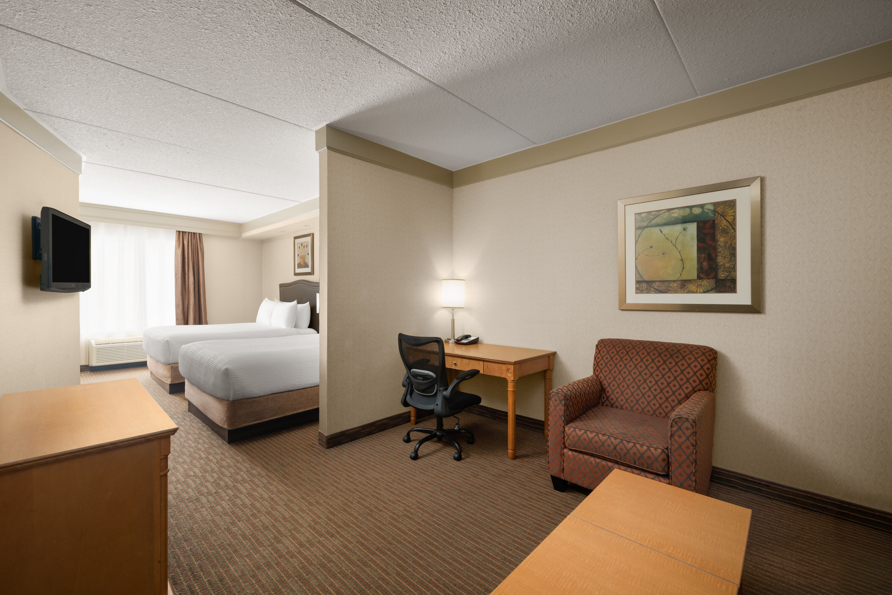 Guest room at the Waterloo Suites Hotel, Trademark Collection by Wyndham in Waterloo, Ontario