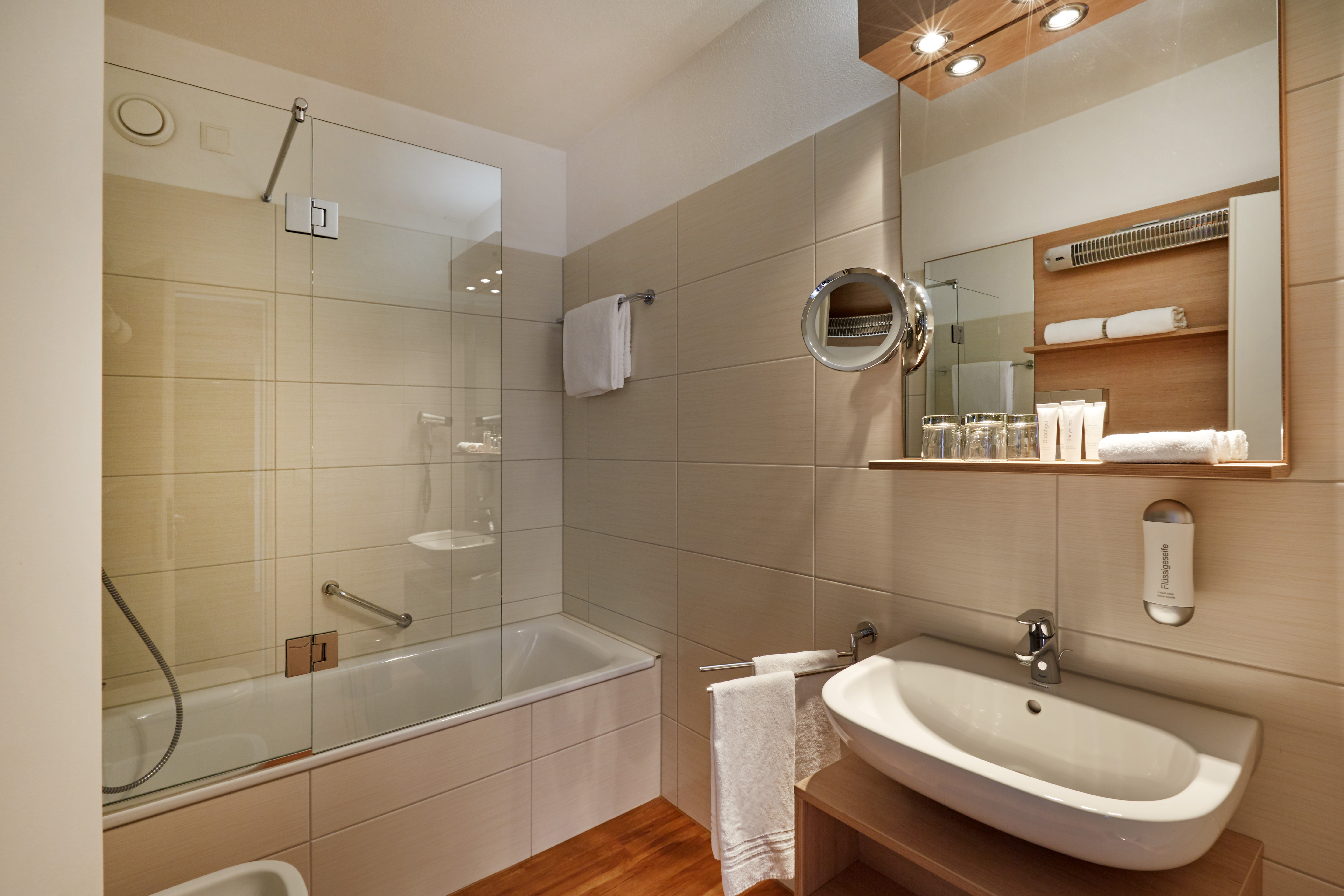 Guest room bath at the H4 Hotel Arcadia Locarno in Locarno, Other than US/Canada