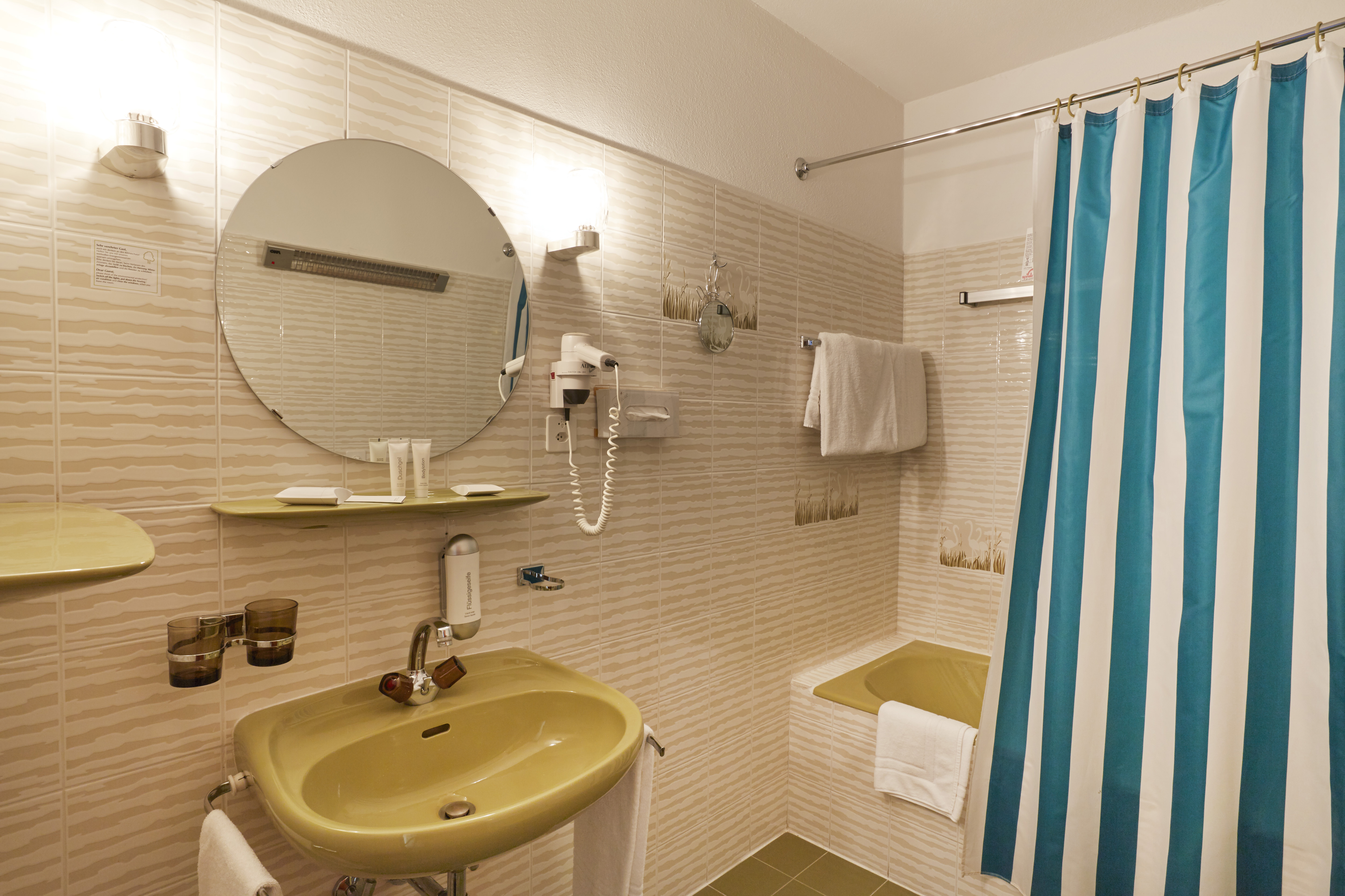 Guest room bath at the H4 Hotel Arcadia Locarno in Locarno, Other than US/Canada