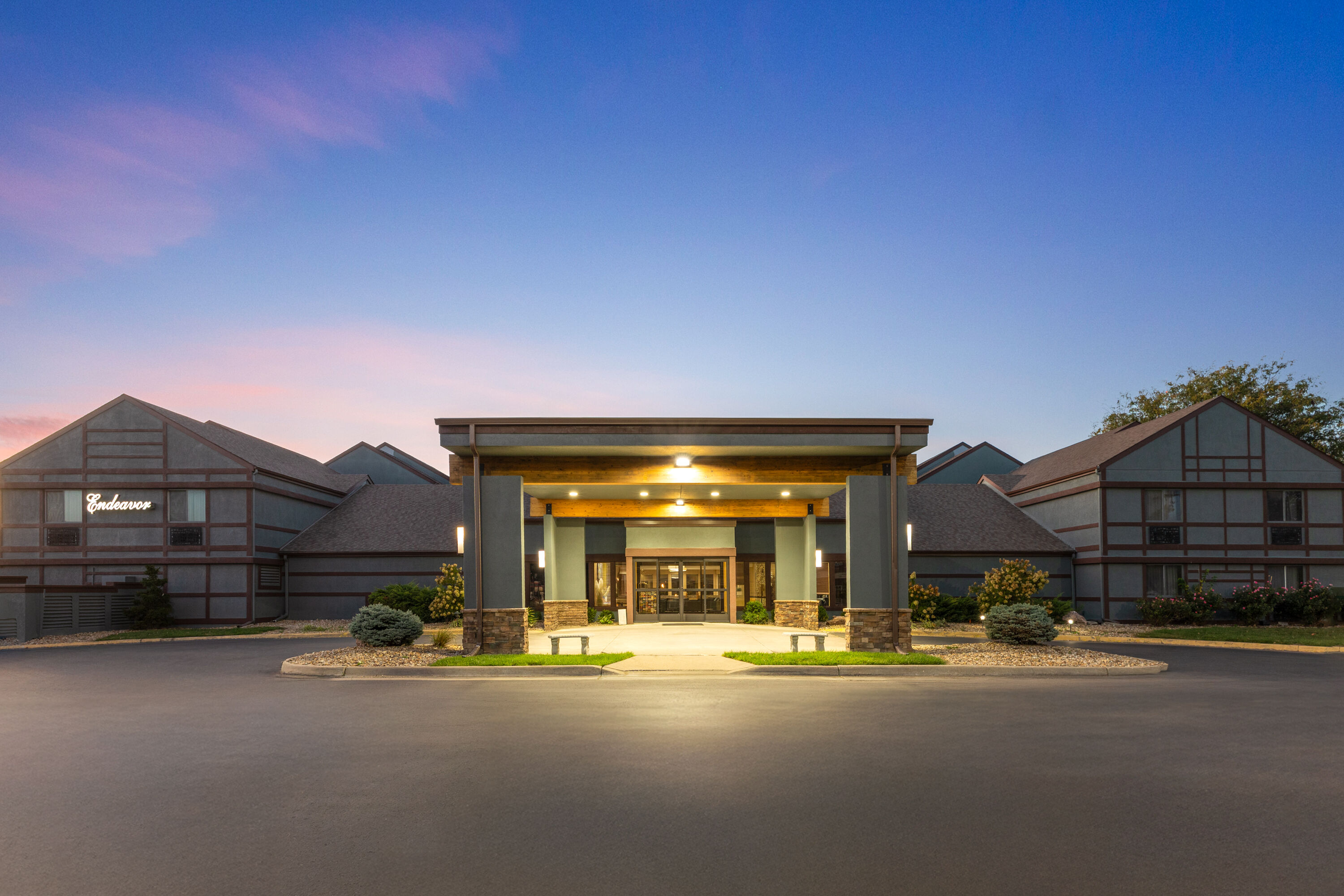 Exterior Dusk Image of Endeavor Inn & Suites, Trademark Collection by Wyndham hotel in Topeka, Kansas