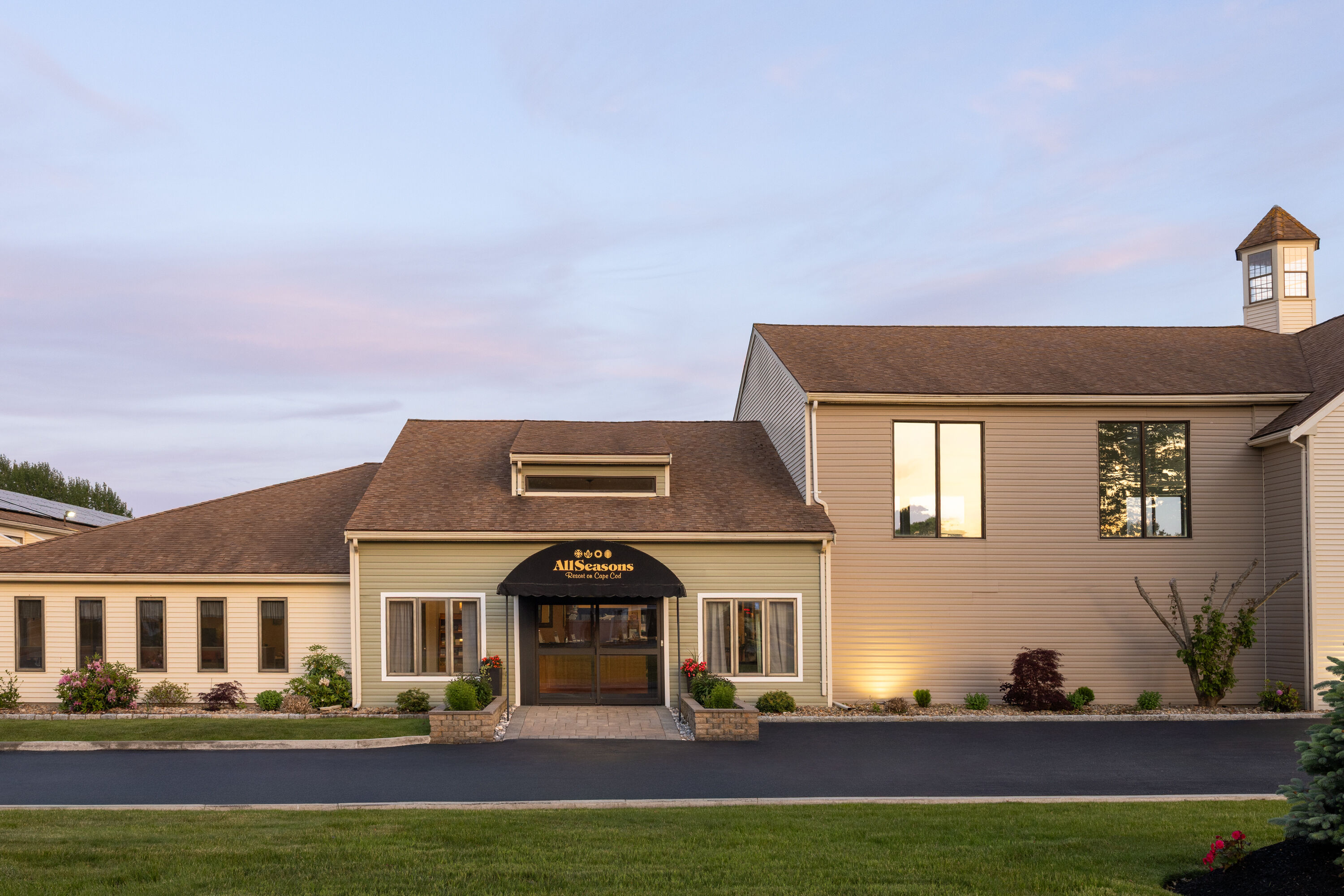 Exterior Dusk Image of All Seasons Resort, Trademark Collection by Wyndham hotel in South Yarmouth, Massachusetts