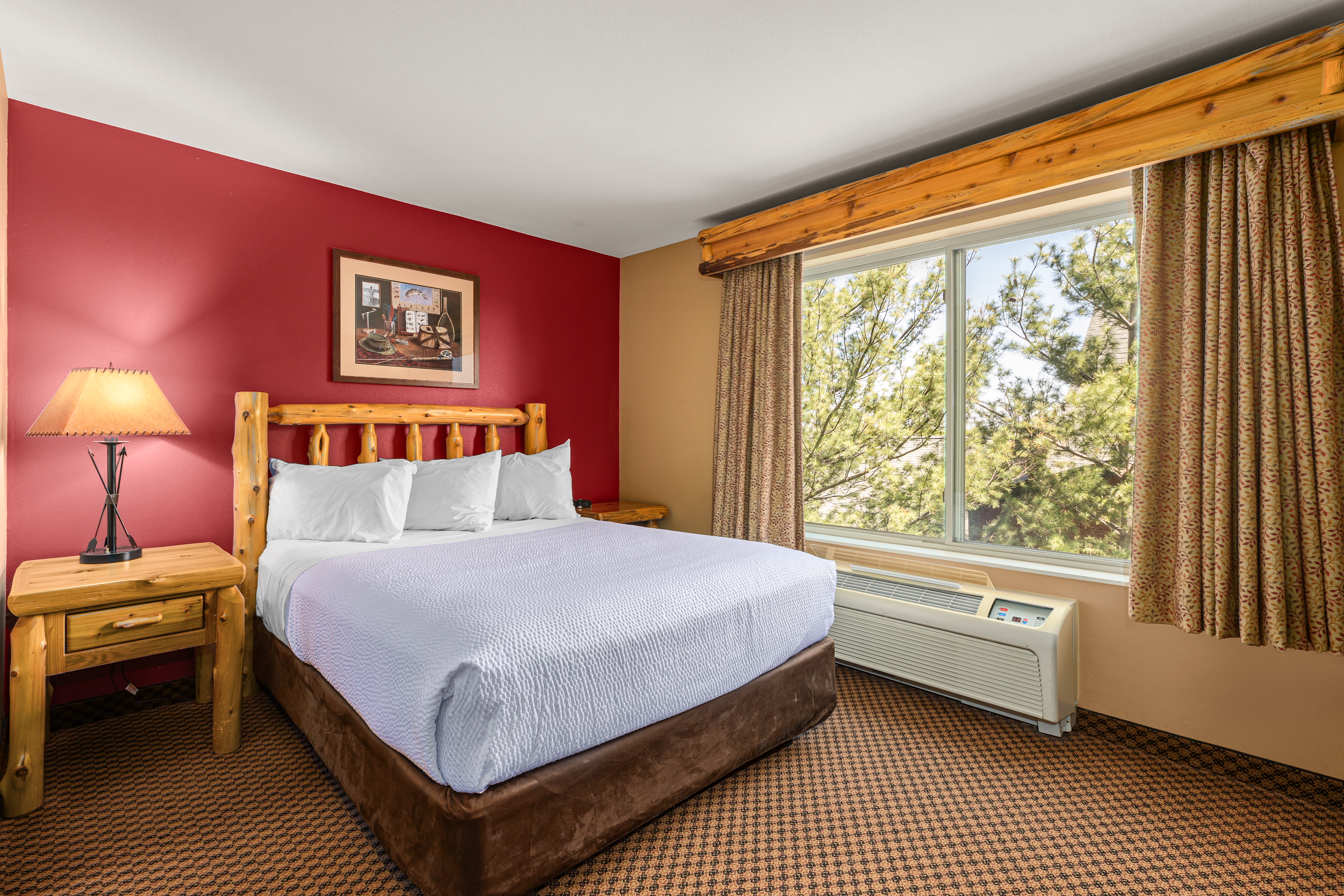 Queen bed guest room at the The Lodge at Brainerd Lakes, Trademark Collection by Wyndham in Baxter, Minnesota