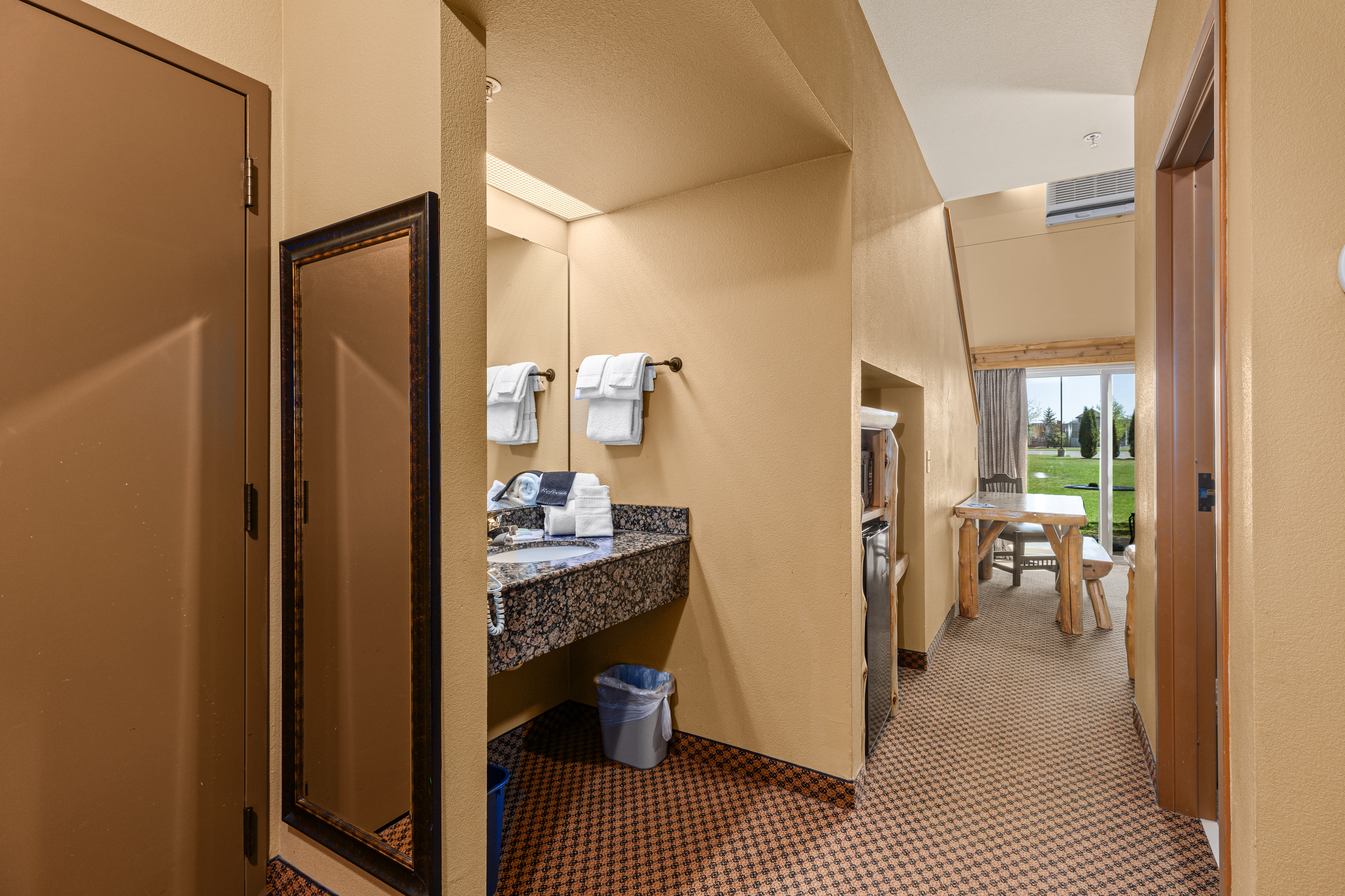 Queen bed guest room at the The Lodge at Brainerd Lakes, Trademark Collection by Wyndham in Baxter, Minnesota