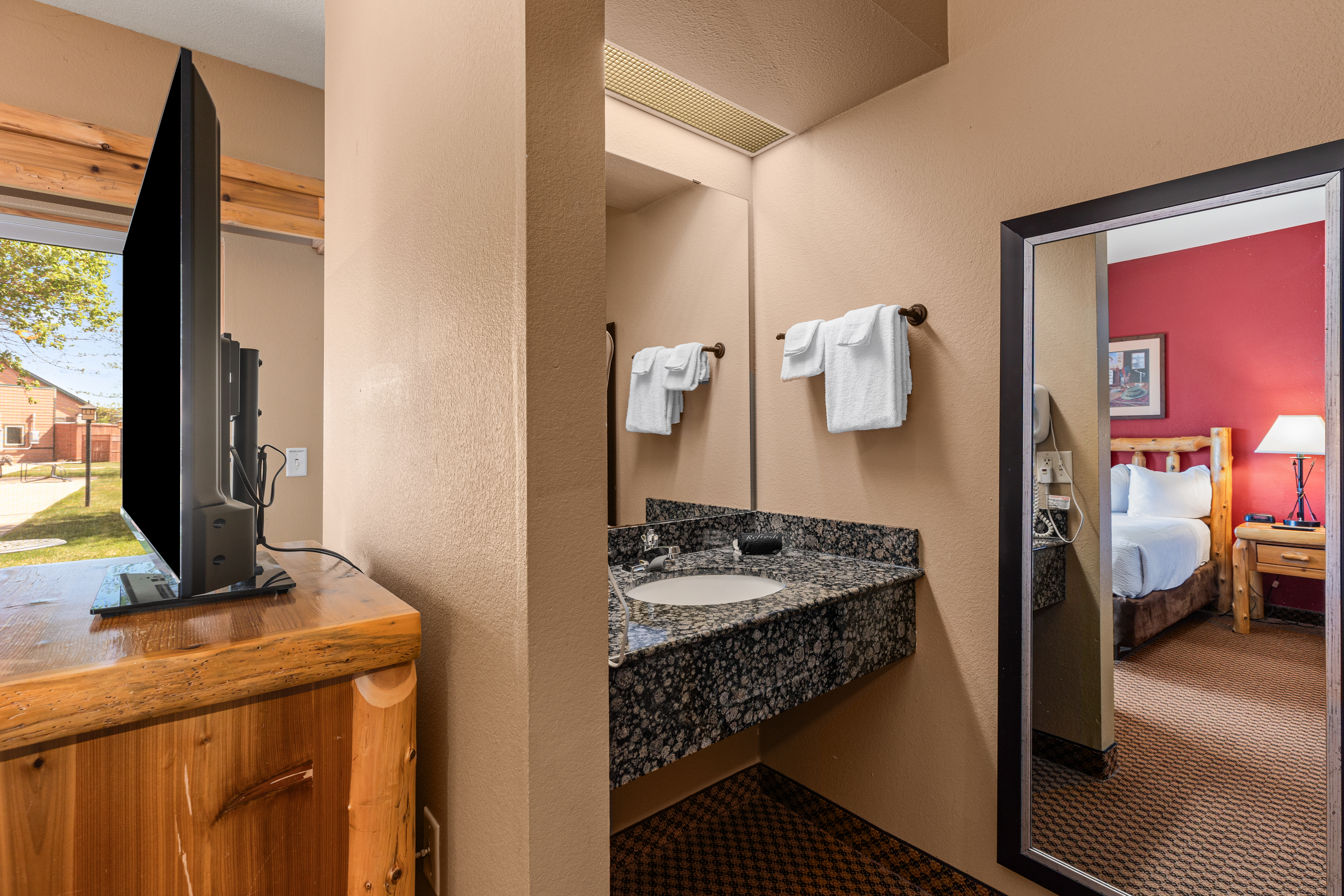 Queen bed guest room at the The Lodge at Brainerd Lakes, Trademark Collection by Wyndham in Baxter, Minnesota