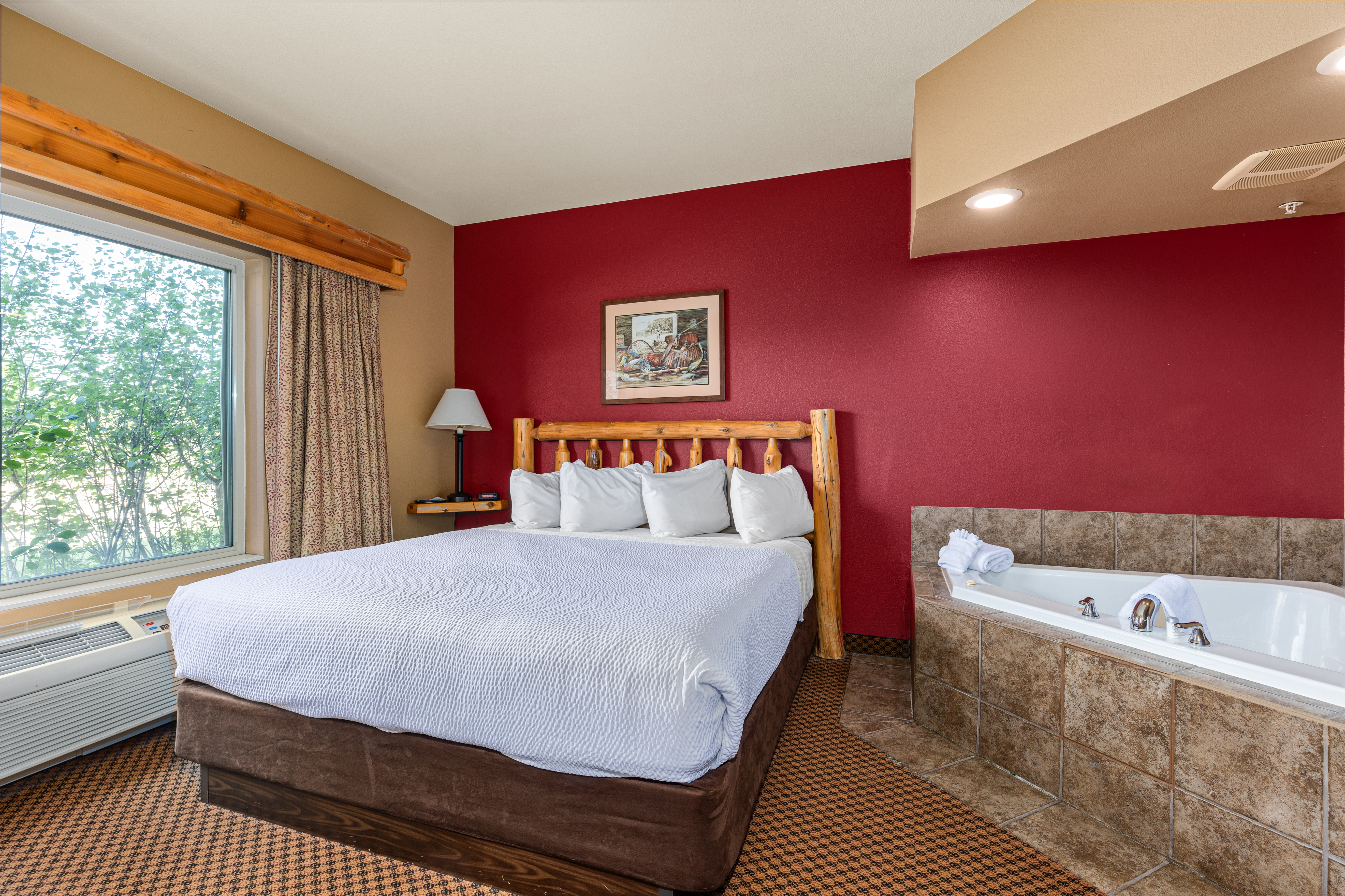 King bed guest room at the The Lodge at Brainerd Lakes, Trademark Collection by Wyndham in Baxter, Minnesota