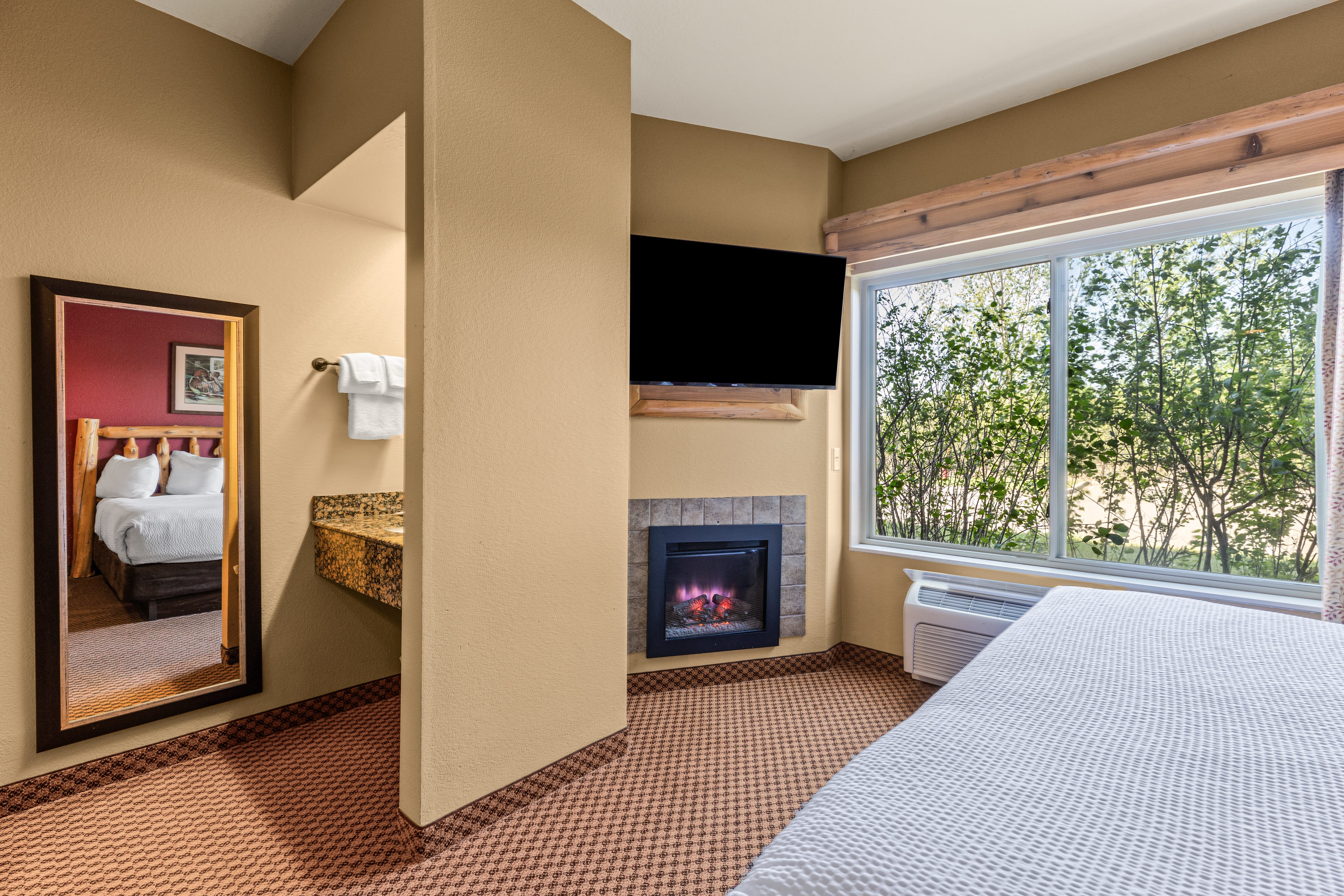 King bed guest room at the The Lodge at Brainerd Lakes, Trademark Collection by Wyndham in Baxter, Minnesota