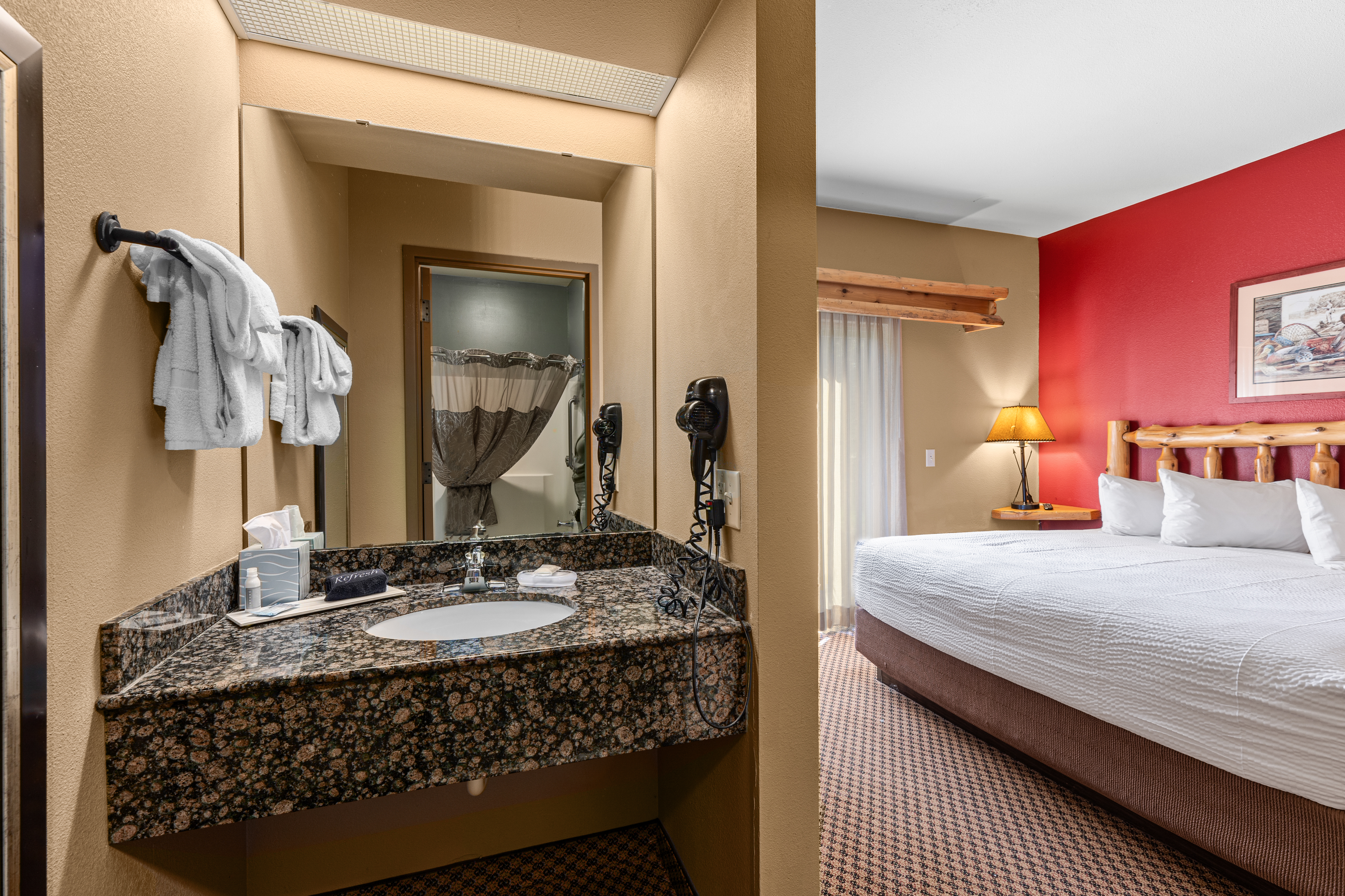 King bed guest room at the The Lodge at Brainerd Lakes, Trademark Collection by Wyndham in Baxter, Minnesota