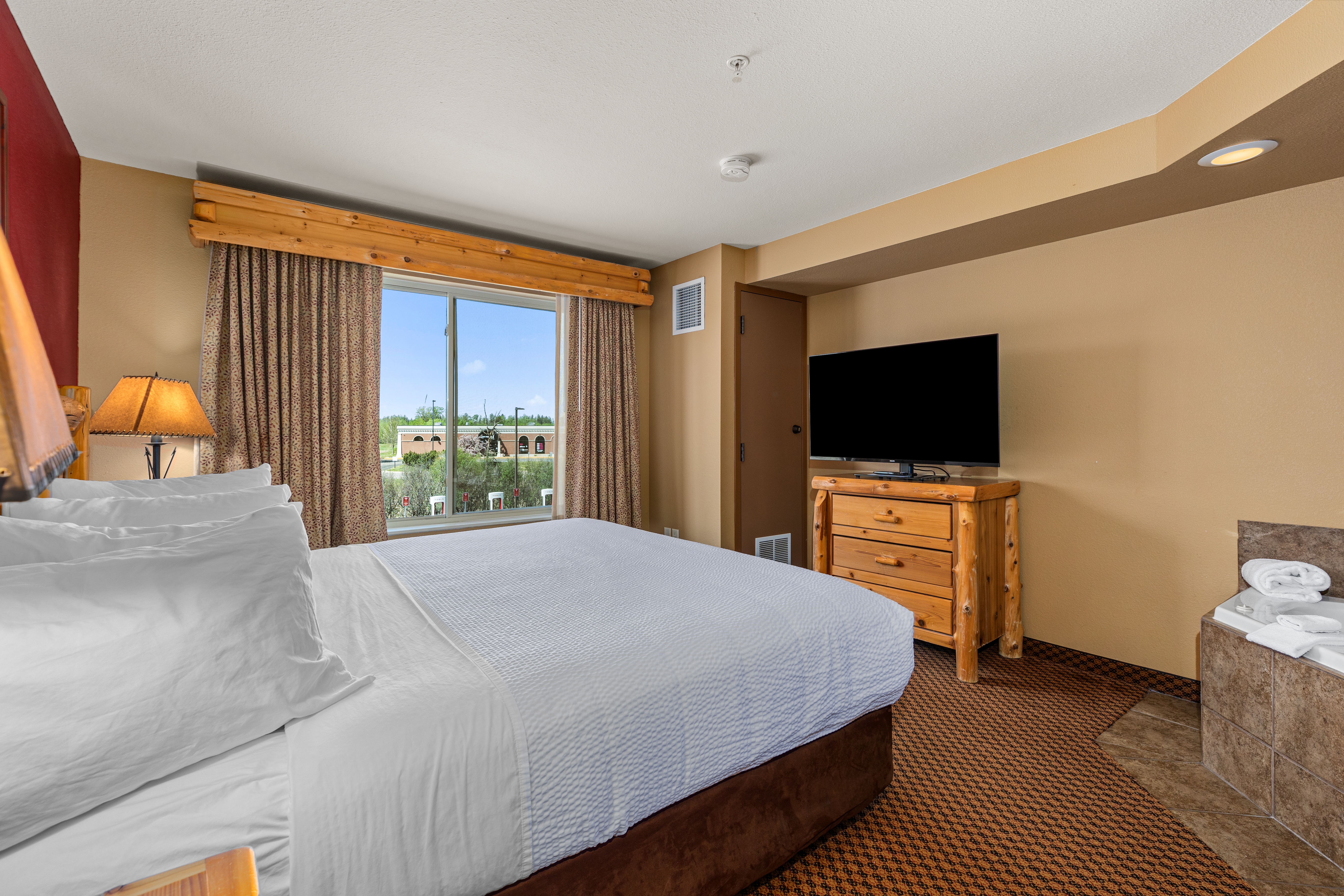 King bed guest room at the The Lodge at Brainerd Lakes, Trademark Collection by Wyndham in Baxter, Minnesota