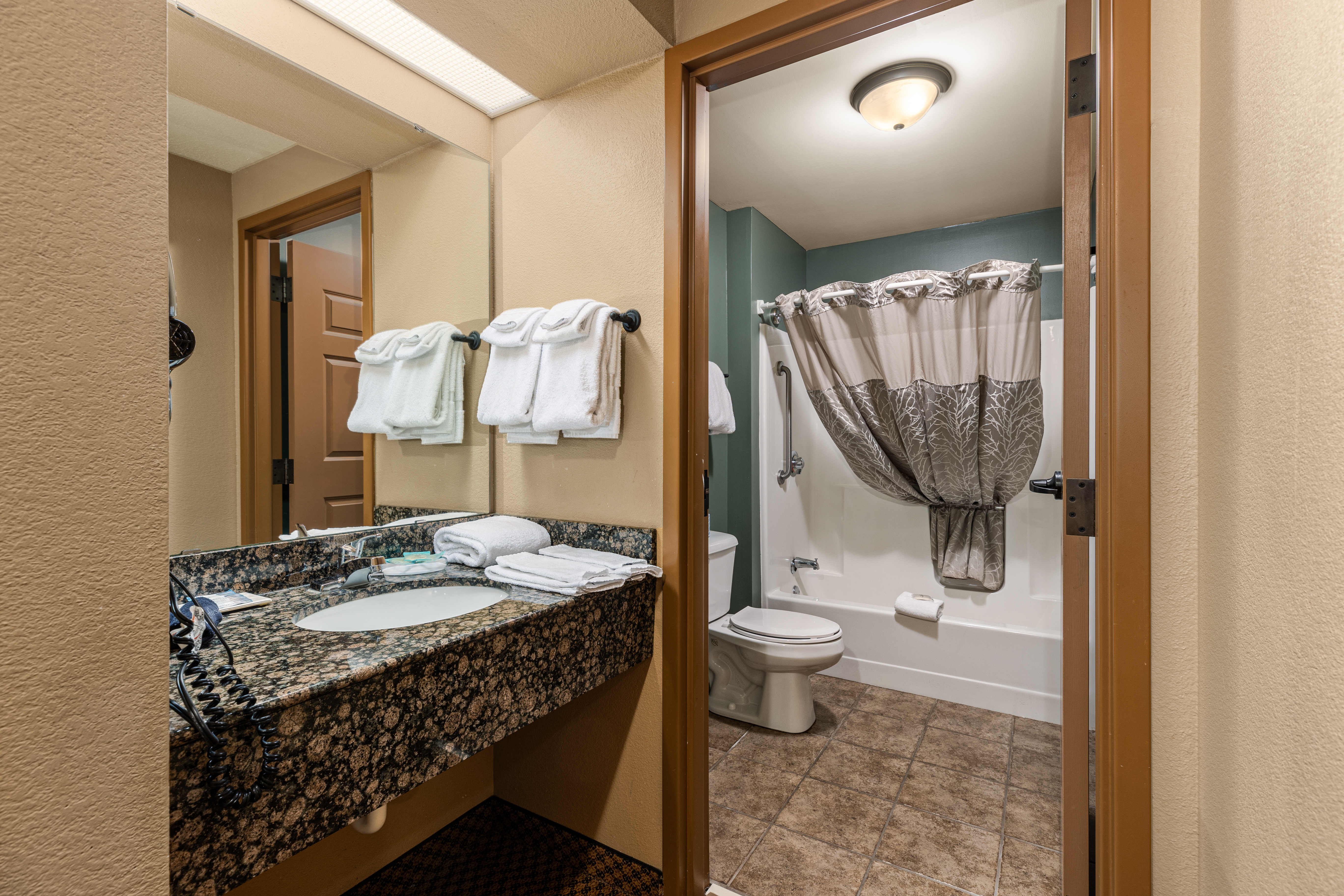 King bed guest room at the The Lodge at Brainerd Lakes, Trademark Collection by Wyndham in Baxter, Minnesota