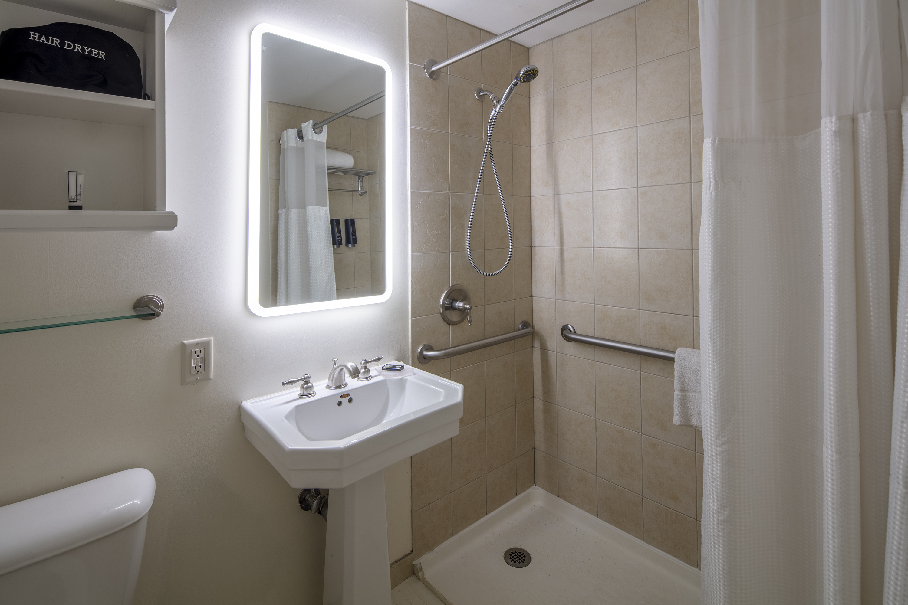 Guest room bath at the Collegian Hotel & Suites, Trademark Collection by Wyndham in Syracuse, New York