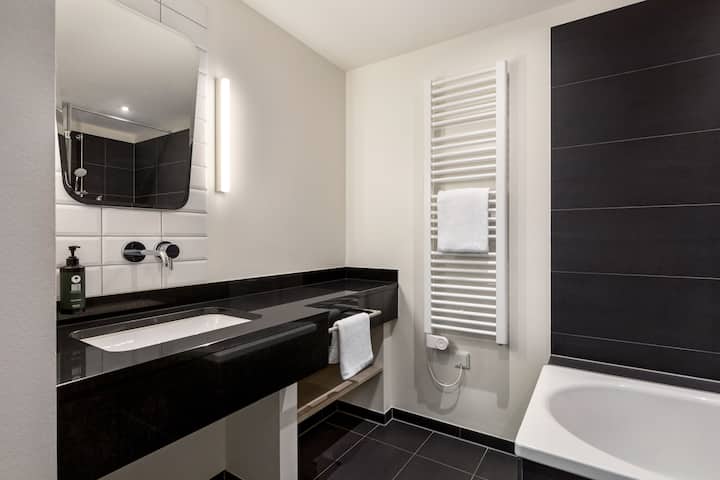 Guest room bath at the Vienna House Easy by Wyndham Osnabruck in Osnabrueck, Other than US/Canada
