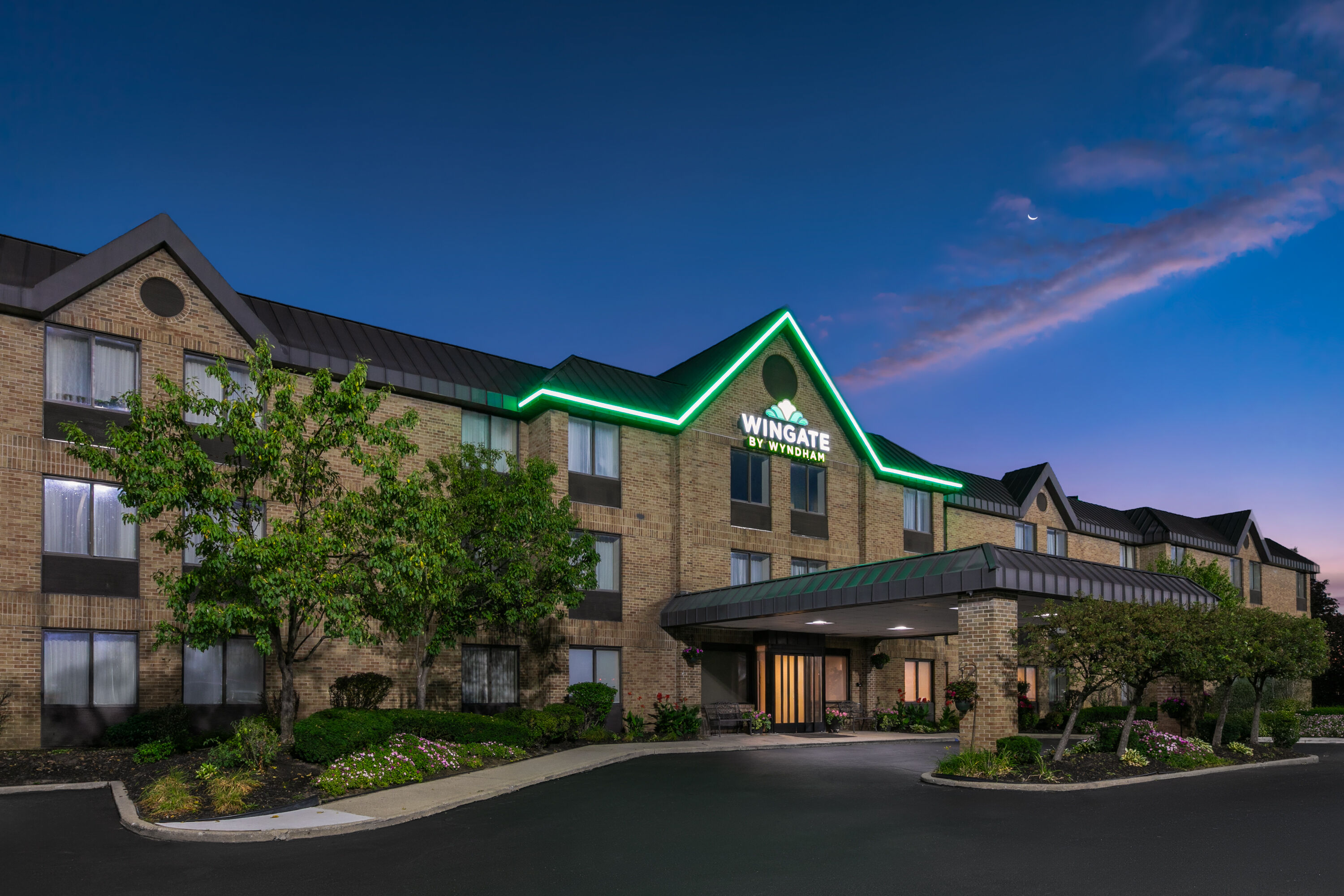 Exterior Dusk Image of Wingate by Wyndham Utica hotel in Utica, Michigan