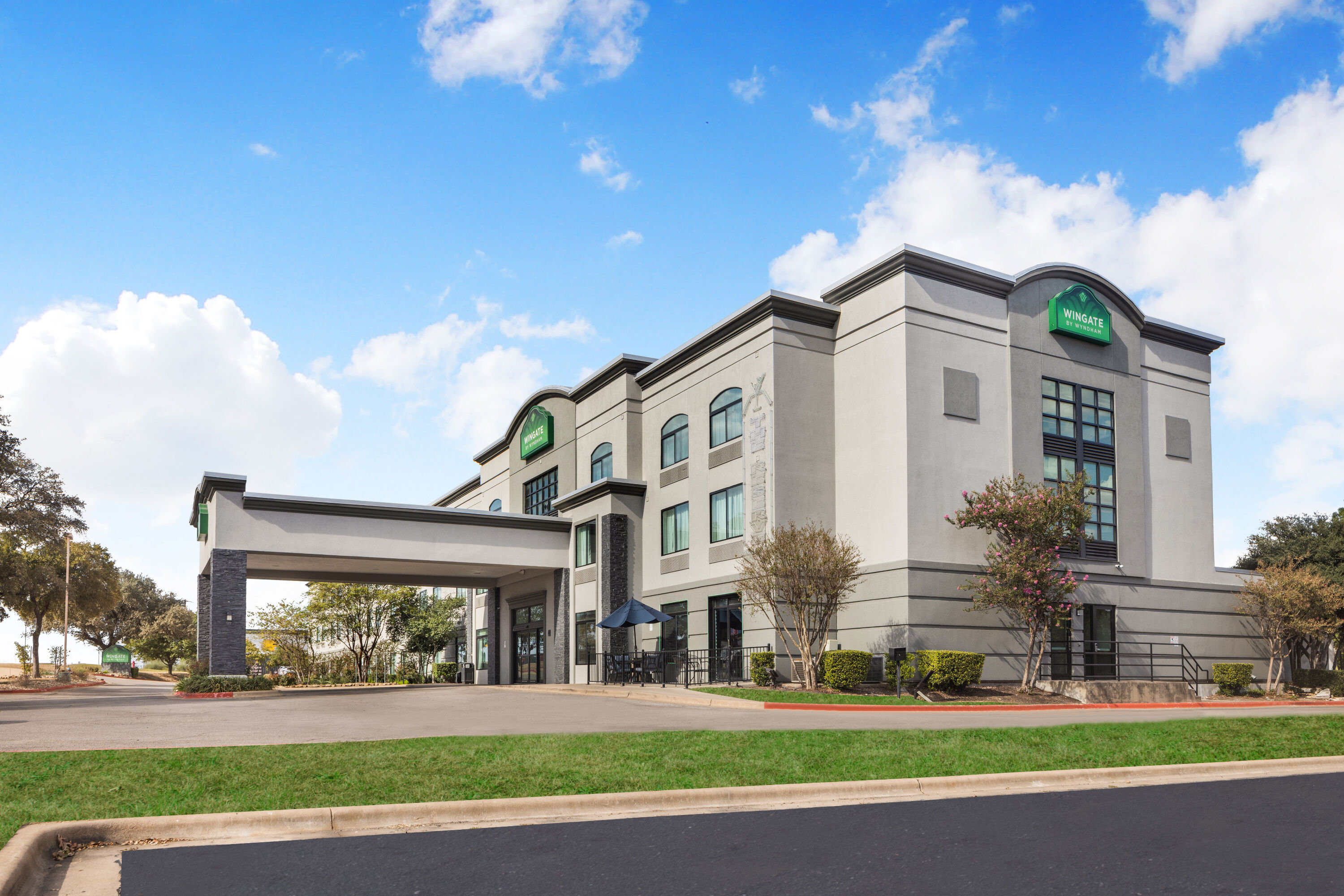 Exterior Day Image of Wingate by Wyndham Round Rock Hotel & Conference Center hotel in Round Rock, Texas