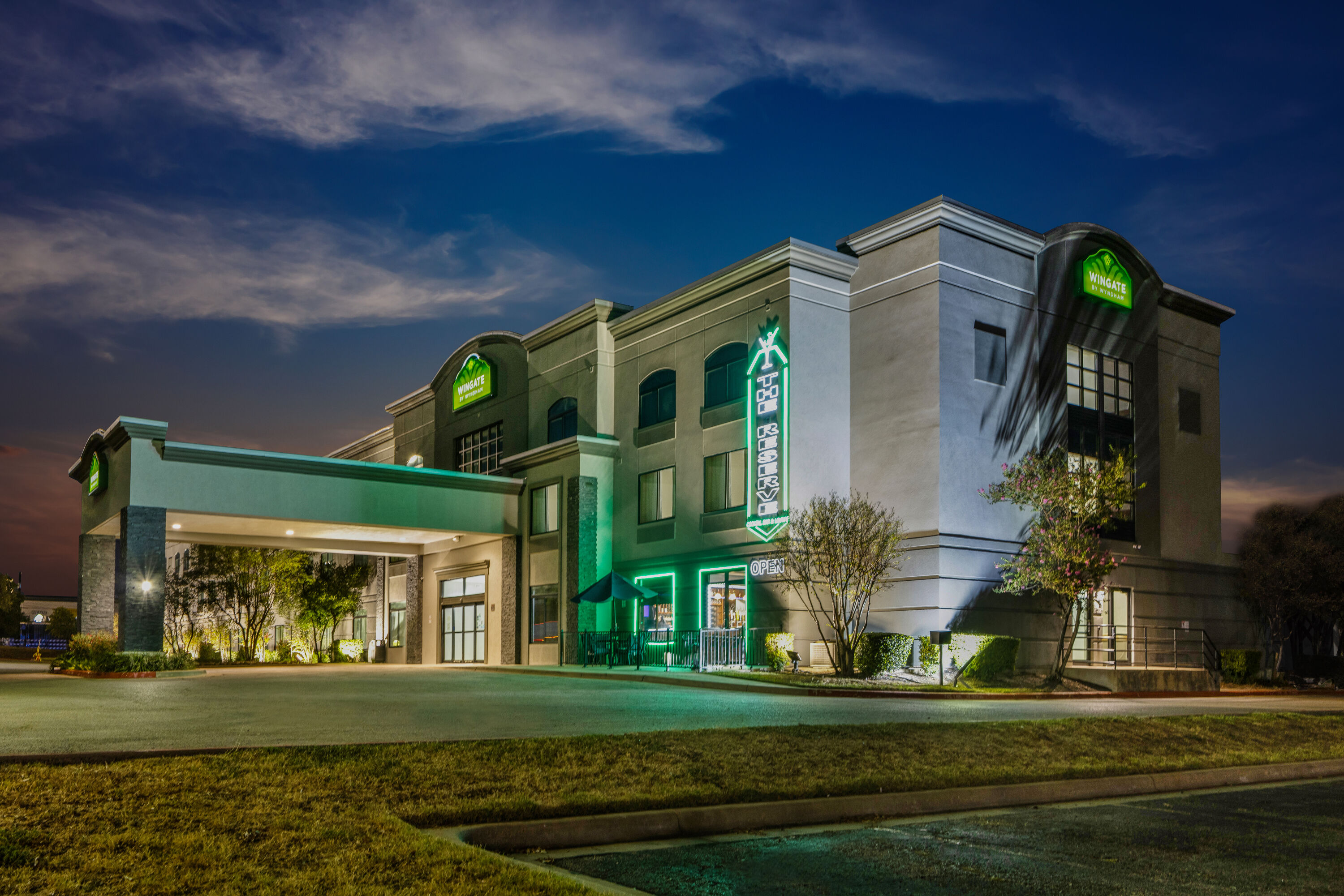 Exterior Dusk Image of Wingate by Wyndham Round Rock Hotel & Conference Center hotel in Round Rock, Texas