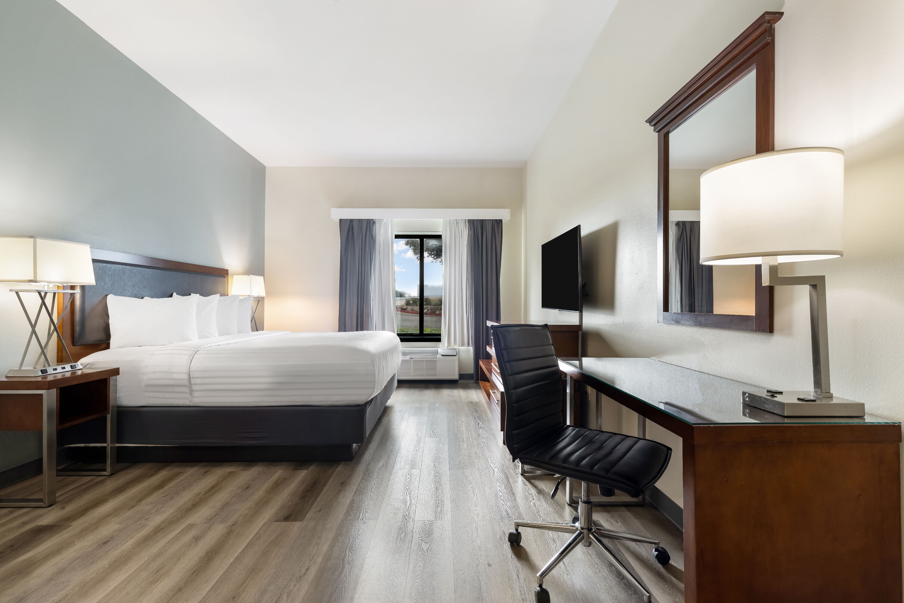 King bed guest room at the Wingate by Wyndham Round Rock Hotel & Conference Center in Round Rock, Texas